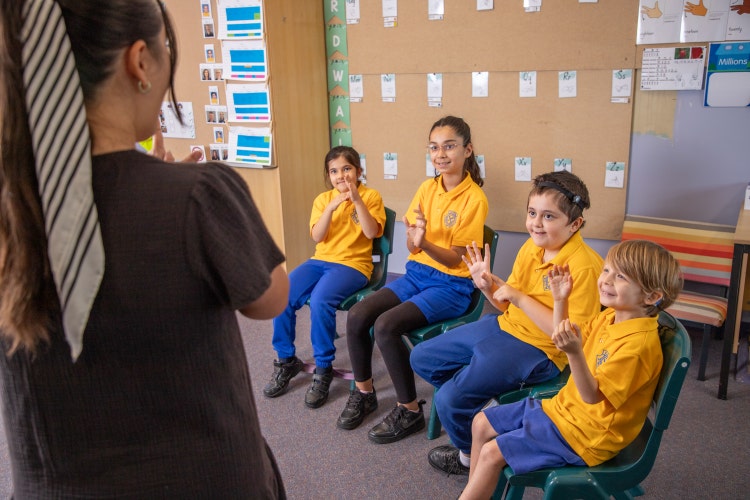 SLSO signing with students in classroom
